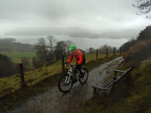  Lee leaving Skelghyll Woods, with Lake Windermere merging with the clouds behind.