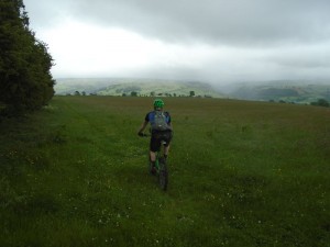 Tom descending through the fields on the Ceiriog Trail.