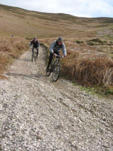 Chris on the loose gravel of the Moel Dywyl descent, into the Vale of Clwyd.