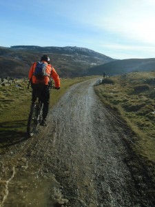 Lee climbing County Road with Moel Famau in the background.  