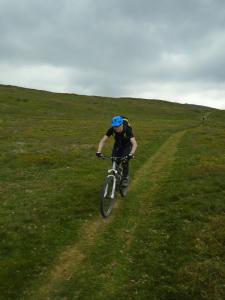 Adrian on the long, grassy descent from Moel Famau into Vale of Clwyd.