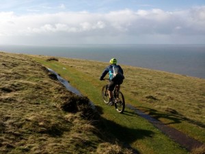 Matty riding towards the Irish Sea on Wales Coast Path.