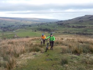Brian and Jan pushing through the field, on the Pennine Way, from Gaudy House.
